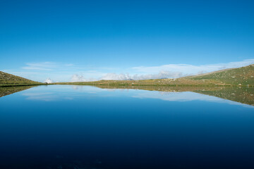 Reflection of clouds in the blue sky in the lake.Reflections in the glacial lake. Reflections on Kilimli lake. Lakes on top of Uludağ, Kilimli Lake, Bursa, Türkiye.