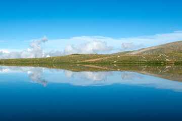 Reflection of clouds in the blue sky in the lake.Reflections in the glacial lake. Reflections on Kilimli lake. Lakes on top of Uludağ, Kilimli Lake, Bursa, Türkiye.