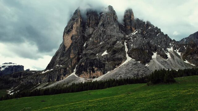 4k Drone Flys Fast Over Dandelion Field Torward Mountain At Seiser Alm, Dolomites In Northern Italy