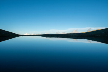  Reflection of clouds in the blue sky in the lake.Reflections in the glacial lake. Reflections on Kilimli lake. Lakes on top of Uludağ, Kilimli Lake, Bursa, Türkiye.