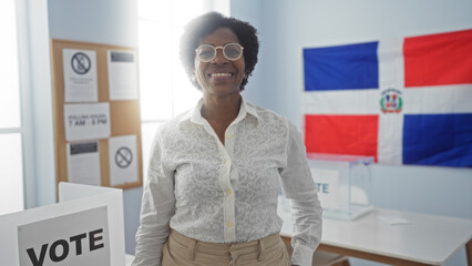 Woman with curly hair smiles in an electoral college room in the dominican republic with a vote...