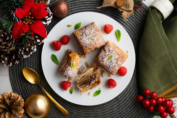 Miguelitos are typical pastries from Spain made from puff pastry. Top view table with christmas decoration.