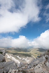 Snowy mountains and blue sky in the background. Snowy mountains with magnificent white clouds. Uludağ hiking routes. Clouds over Bursa Uludağ mountains. Blue sky, snowy and cloudy hills.