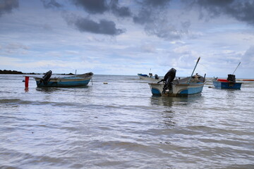 fishing boats in the sea against the background of high-rise modern buildings