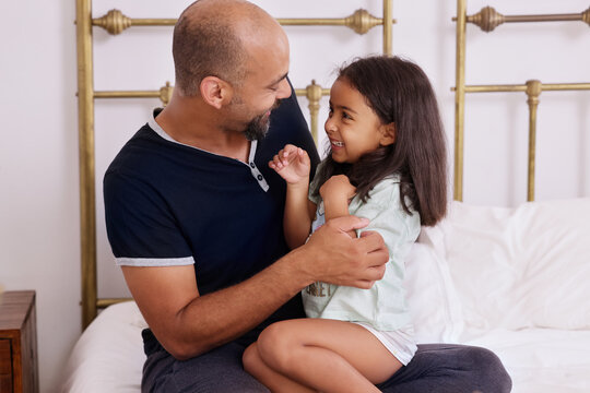 Father with daughter on bed