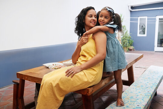 Mother and daughter on patio