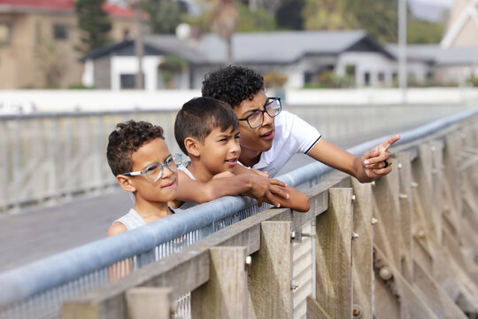 Boys standing on bridge
