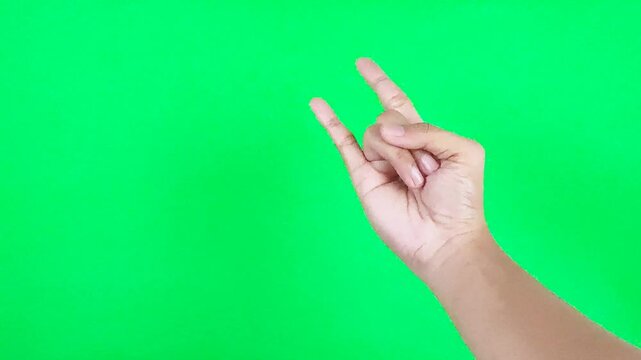 Metal hand sign with shaked motion isolated on green screen background chroma key