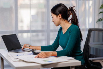 Accountant working on desk using laptop documents calculator to calculate financial report in office business accounting finance concept
