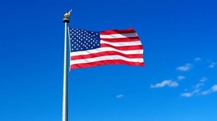Fototapeta premium Waving American Flag at Under a Clear Blue Sky