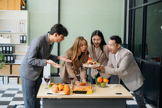 Young Asian Professionals Celebrating with Pizza and Drinks in a Modern Office Setting - Powered by Adobe