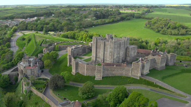 Drone footage showcasing Dover Castle, England from above, highlighting its medieval architecture and surrounding green fields.