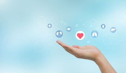 close up young woman hand gesture and show about internal organ donation of human cell on blue background for kindness of living and medical nonprofit concept