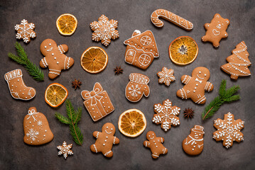Set of Christmas gingerbread cookies on dark background, top view, flat lay