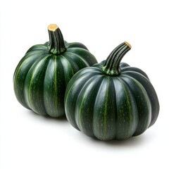 A pair of acorn squash with deep green skin and ribbed texture symbolizing autumn vegetables isolated on white background 
