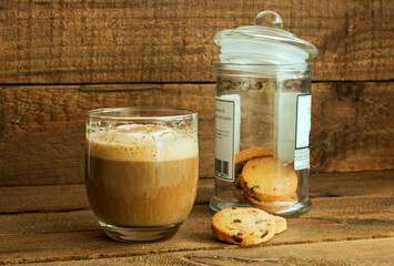 Delicious coffee and cookies, on a wooden background