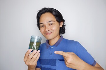 portrait of a long-haired Indonesian man wearing blue clothes with random poses isolated on white background