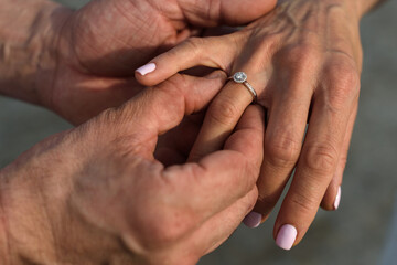 marriage proposal and heart ring on finger