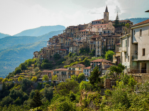 Italian Village Apricale with Stone Buildings, Flower Pots, and Rustic Signs.