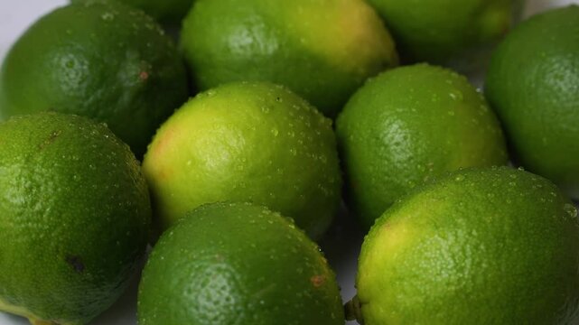 Lime green lemon citrus fruit fresh crips water splash drops up close rotating