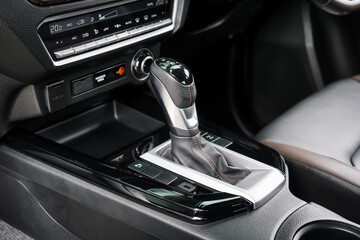 automatic transmission shift selector in the car interior. Closeup a manual shift of modern car gear shifter. 4x4 gear shift