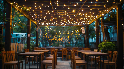 Fototapeta premium A canopy with string lights over an outdoor dining area, creating a cozy and inviting atmosphere for celebrating special occasions in the evening light.