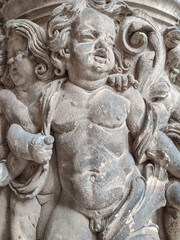 Obraz premium Dresden, Germany, old art sculptures, column stucco molding of young boys as angels, slaves and soldiers, gatekeepers