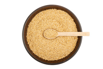 Flax seeds in a plate and a wooden spoon in it