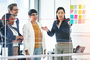 Business people, presentation and glass wall for teamwork, brainstorming and collaboration in...