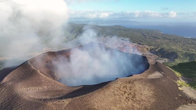 Crater with hot smoke of Vanuatu active volcano. Mount Yasur, Tanna Island. Birds eye view, beautiful day.