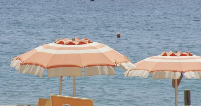 Umbrellas At The Beach Of Monterosso al Mare, Cinque Terre, Italy. Close-up Shot
