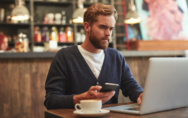 Man, phone and serious with laptop in coffee shop for ecommerce, online banking and lunch break. Remote work, freelancer and customer with smartphone for multitasking, relax and networking in bistro