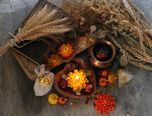 magic Ritual, witchcraft. amulets, flowers, candles, wizard items, witch cauldron, wheat ears and...