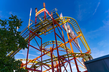 Looking up roller coster named cat and mouse at fun fair named Knabenschiessen at Swiss City of Z&uuml;rich on a sunny late summer afternoon. Photo taken September 6th, 2024, Zurich, Switzerland.