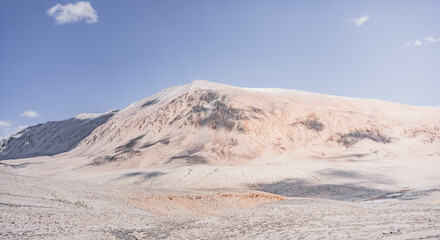 Panoramic landscape of textured Tien Shan mountains in Pamir in Tajikistan, panoramic landscape of a mountain range with snow and glaciers in summer