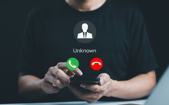 Fraud and phishing concept. Man holding mobile phone with incoming call from unknown caller. scammer or stranger, Hoax person with fake identity, Prank caller, anonymous, smartphone, unwanted, spam,