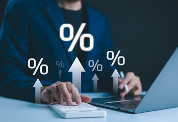 Interest rate increase concept. Businessman use a calculator and laptop with percentage symbols and upward arrows, symbolizing rising interest rates. financial growth, dividend yield, income, expenses