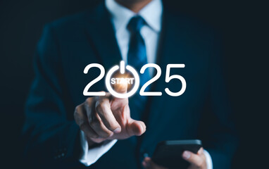 2025 start button press concept. Businessman presses digital start button integrated into the year...