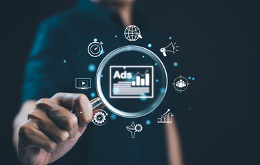 Analyzing online advertising campaigns and performance. A magnifying glass focusing on 
