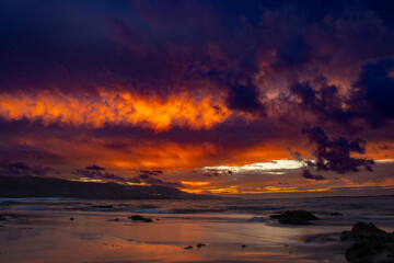Sunset on the las palmas de gran canaria city beach, las canteras with mountain teide at background