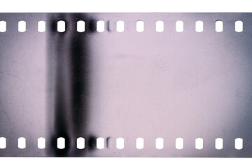 Dusty and grungy 35mm film texture or surface. Perforated scratched camera film isolated on white background.