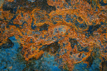 Rusty metal surface with shabby background paint. Blue cracked paint texture on an iron sheet. Fragment of an old metal door, Metal corrosion.