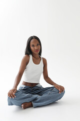 Vertical headshot of young woman with dark skin looking at the camera.