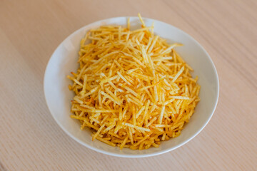 Bowl of crispy potato sticks, perfect for snack time or party appetizers