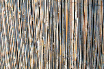 Close-up of a rustic bamboo fence, symbolizing eco-friendly construction and natural privacy solutions for sustainable living designs