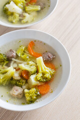 A comforting bowl of homemade vegetable and meatball soup perfect for a healthy winter meal or flu recovery