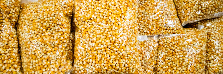 Bags of yellow popcorn kernels ready for snack preparation or movie night festivities, highlighting the importance of convenient bulk food storage