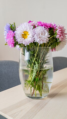 A bouquet of colorful chrysanthemums in a glass vase, perfect for Mother's Day or home decoration, symbolizing love and cheerfulness