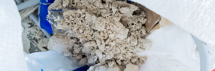 Dried cement mixture in a construction site bag highlighting environmental waste problems in urban development projects