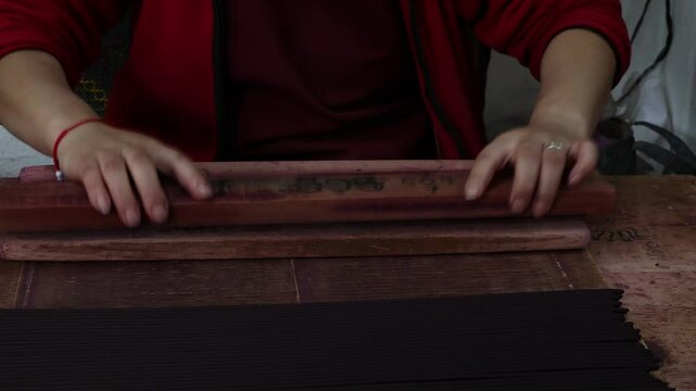 Woman manufacturing Incense sticks in Nado Poizokhang Thimphu, Bhutan